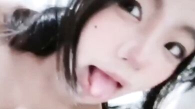 Girl sticks out her tongue on the bed