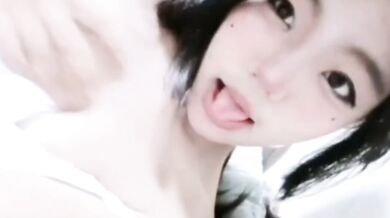 Girl sticks out her tongue on the bed