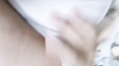 Girl sticks out her tongue on the bed