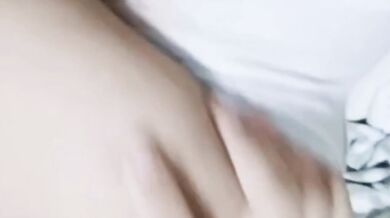 Girl sticks out her tongue on the bed