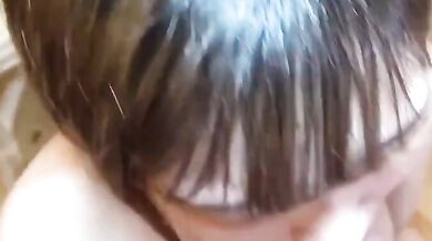 Sucking on a breast and smiling happily