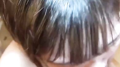 Sucking on a breast and smiling happily