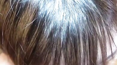 Sucking on a breast and smiling happily