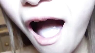 Sucking on a breast and smiling happily