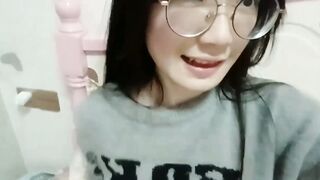 Glasses-wearing girl flaunts cleavage and legs in selfie