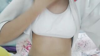 Cute sister touches breasts in bedroom