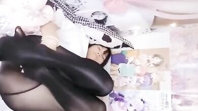 Cute girl in black silk uniform seduces