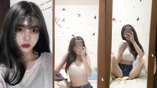 Sexy girl with breast tattoos in front of mirror
